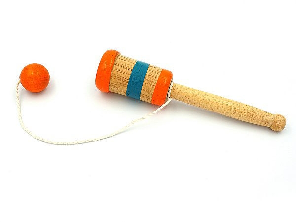 Wooden ball catch game with brown stick and orange and blue stripes with orange attached ball.