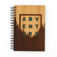 Adventure Journal - front with wood cover. Adventure in green capital letters with tree range in dark on bottom and light wood sky