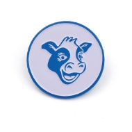 Round shaped pin with a white background and blue outline.  Inside is a illustrated blue outline of a cow head with his mouth ajar in a smile.