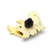 The back of the pin is gold with a black rubber stopper.