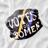 Black cloth mask with white straps. One yellow and one blue diagonal slash each run across the mask behind the white text "Votes for Women"