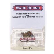 Lapel pin shaped as the Wade House historic site logo. The top half of the logo is a man driving a carriage driven by two horses talking to a man and women dressed in old-fashioned clothing. Under that image is the site name "Wade House" in a red banner, and "A Wisconsin Historic Site" underneath.