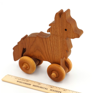 Handcrafted Wooden Fox Push Toy Cherry next to ruler