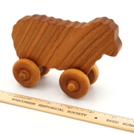 Handcrafted Wooden Sheep Push Toy Cherry next to ruler