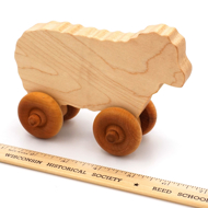 Handcrafted Wooden Sheep Push Toy in Maple next to ruler