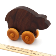 Handcrafted Wooden Bear Push Toy in Walnut next to ruler