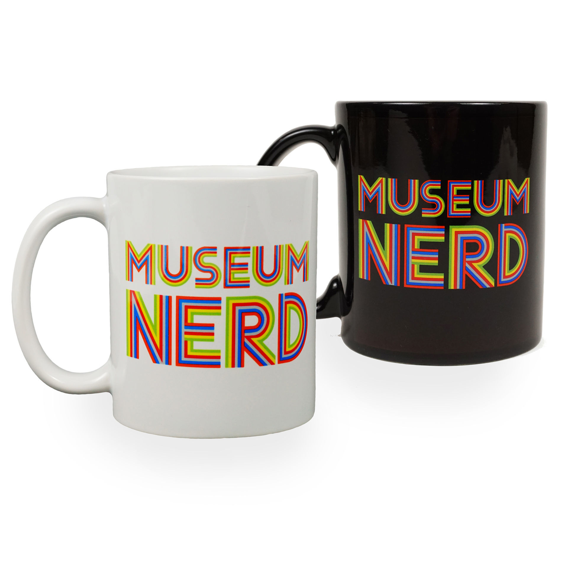 Two mugs, one white, one black, with the words 'Museum Nerd' in stripey tri-colored block lettering