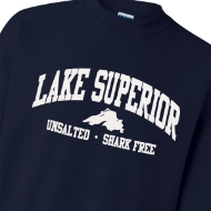 Frontside of a dark, navy blue crew cut sweatshirt. "Lake Superior" is in big lettering with a filled in outline of the lake beneath and the text "Unsalted. Shark Free"