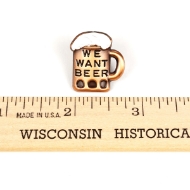 The lapel pin is pictured above a wooden ruler, indicating that it is a half inch wide.