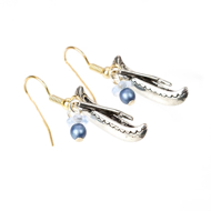 Two miniature canoe earrings with tiny paddles and shepherd hooks.