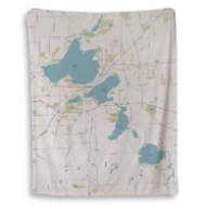 Off-white fleece blanket with map of Madison, Wisconsin and  light bluel akes.