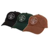 Three baseball caps with embroidered Old World Wisconsin design. Three colors, left to right, black, forest green, and brown.