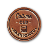 Round, brown, leather coaster that says "Call me old fashioned."