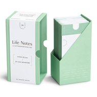 Green box of "Life Notes" open to show contents of light green envelopes that hold the individual themed notes.