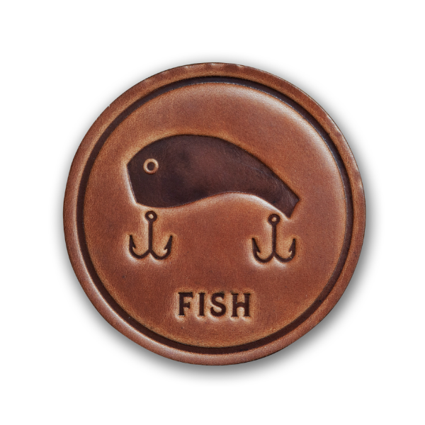 Round leather coaster, medium brown, with a fishing lure design embossed and the word "fish" underneath the lure.