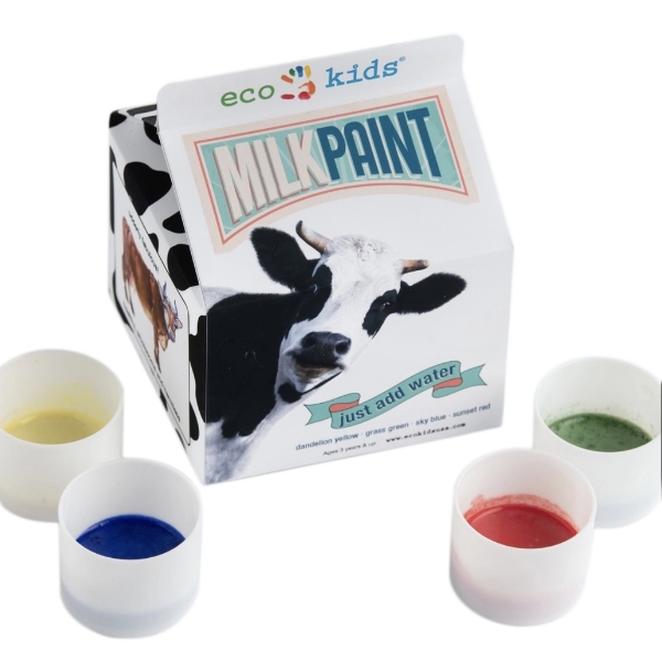 Carton of milk paint with a picture of a cow on it, and four little containers of paint: yellow, blue, red, and green.