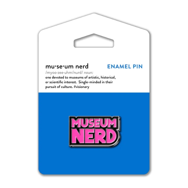 Museum Nerd pin  with pink enamel text that says "Museum Nerd." The pin is mounted on blue display card.