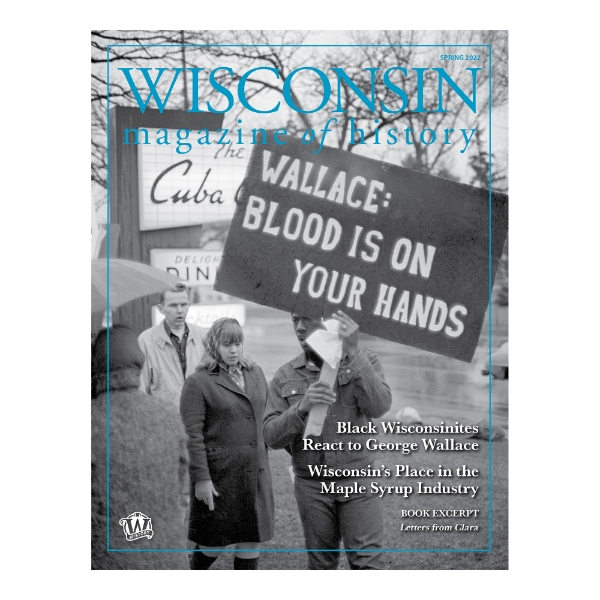 Cover of Spring 2022 issue of the Wisconsin Magazine of History with a black and white photo of 4 people outside on a winter day. One of the people is holding a sign that says "Wallace: Blood is on your hands."