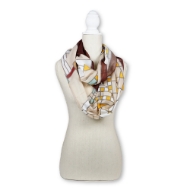 FLW Tree of Life Infinity Scarf draped over a model mannequin. Scarf features a maroon border with tan background and maroon geometric lines across filled with various yellows and blues. 