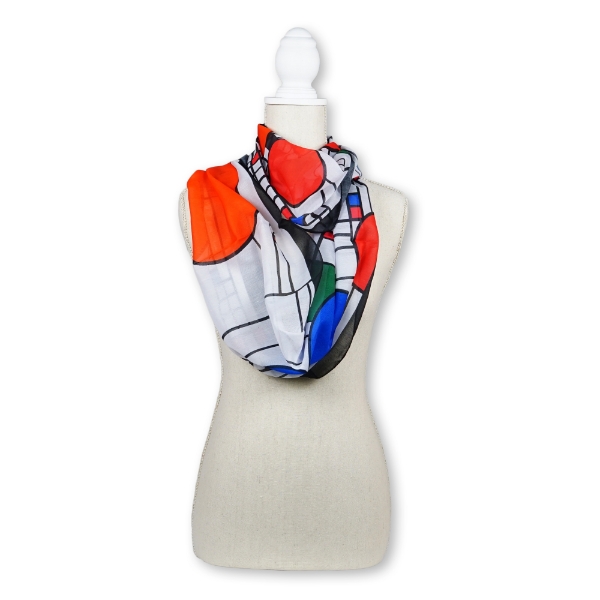 FLW Coonley Infinity Scarf draped on a model mannequin displaying the white with blue and red circles and black geometric lines. 
