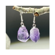 Amethyst Earrings dangling from a small tree branch. Zoomed in to see the gorgeous purple rock coloration. 