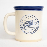 Wisconsin Forward Mudlove Mug with ultramarine blue cup lip and blue graphic showing Wisconsin Barn over the farmfield with "Forward" across the bottom. 