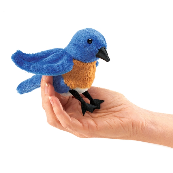 Human hand, palm up, holding a blue, fuzzy, feathery bluebird finger puppet. 