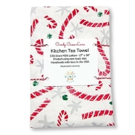 Kitchen tea towel folded into a rectangle and bundled with string. The towel is white with a red and green candy cane print design.