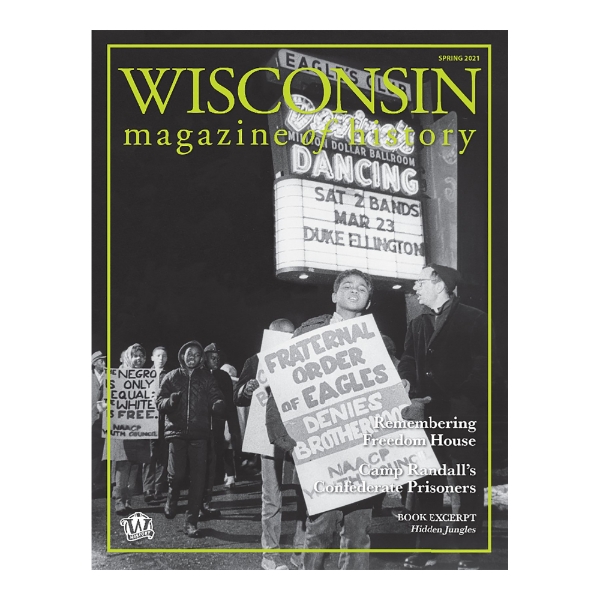 Cover of Wisconsin Magazine of History, Spring 2021, with a full page black and white photo showing young African American walking together and holding signs about equality and the NAACP. A neon sign in the background advertises a Duke Ellington performance.
