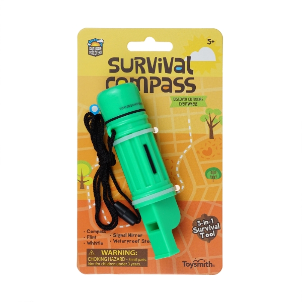 Toy survival compass-whistle (green) mounted on orange display card that says, at the top, "Survival Compass." 