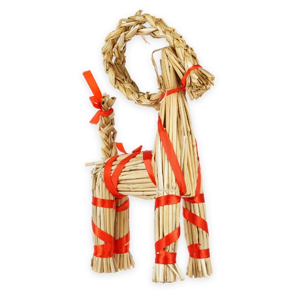 Yule goat home decor item made of tan straw and bound with red ribbon. 