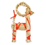 Yule goat home decor item made of tan straw and bound with red ribbon, side profile view. 