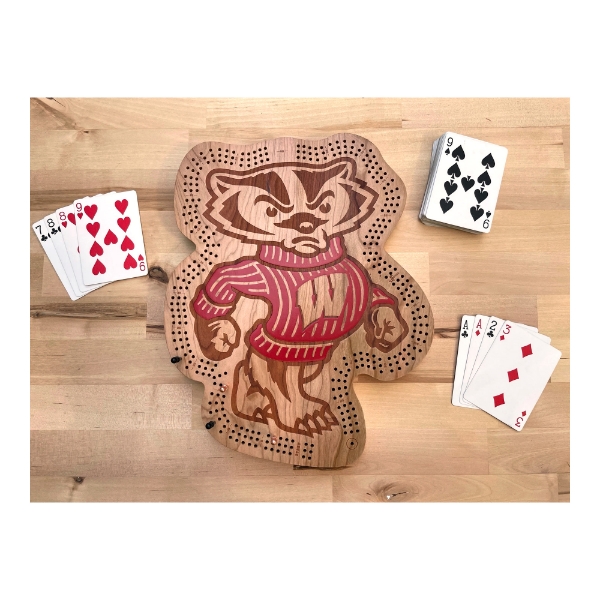 Wood cribbage board cut to the shape of the Bucky Badger mascot, with engraved details and a red sweater. Cribbage track around the perimeter. 