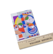 Rectangular refridgerator magnet with colorful, geometric designs by Frank Lloyd Wright. Shown with ruler showing 2.5 inch width.