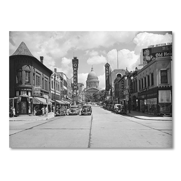 View looking east up State Street from Johnson Street, with the Orpheum and Capitol theatres on either side of the street. Black and white image from 1939.