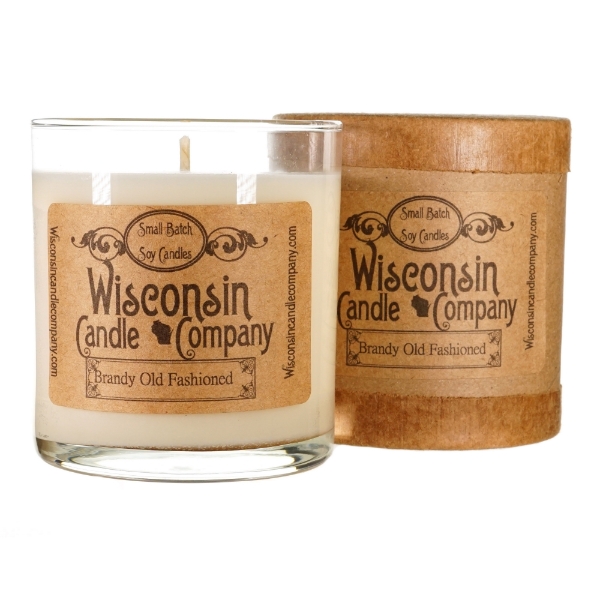 White wax candle in cylindrical clear glass container with kraft-paper label. Black font says Wisconsin Candle Company. 