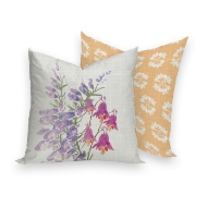 Square decorator pillow with pink wildflower design on one side (white background) and white whildflower motif on reverse (peach background)
