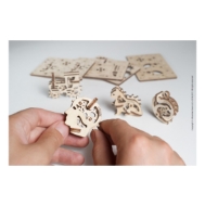 U-Fidget model by UGears, made of laser cut wood parts for the user to assemble.  Shown with two hands in process of assembly or use.