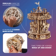 Wood carousel model from UGears shown upside down to reveal winding mechanism and rubber band.