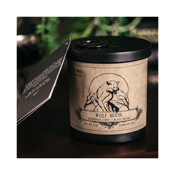 "Wolf Moon" candle from Hex + Wax Candle Company. Dark glass container, black metal lid, tan paper label with black ink.