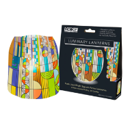 One home decor luminary with multicolored "Saguaro Forms" design by Frank Lloyd Wright. Pictured next to its black packaging.