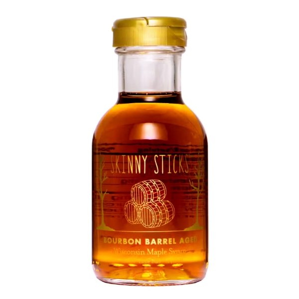 Small clear glass bottle of golden maple syrup. Font in gold ink says "Bourbon Barrel Aged Wisconsin Maple Syrup."