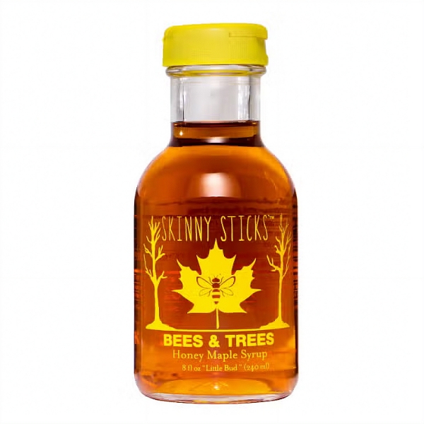 Small clear glass bottle of golden maple syrup. Font in gold ink says "Bees & Trees Honey Maple Syrup."