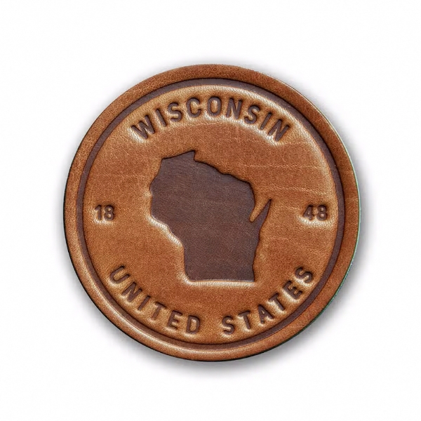 Round leather coaster, brown, with embossed silhouette of the state of Wisconsin and embossed text that reads "Wisconsin, 1848, United States"