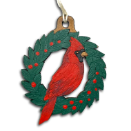 Holiday tree ornament carved from gourd and featuring red cardinal perched in round, green wreath. 