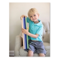 Small child posing with felt play board product.