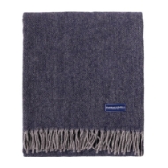 	Detail image of wool Ashby throw from Faribault Mills showing the NAVY heather/fleck weave of the fabric, edge fringe, and Faribault label.