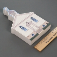 Side angle view of St. Peter's Catholic church home decor miniature, pictured with ruler to show size, about 3.5" wide.