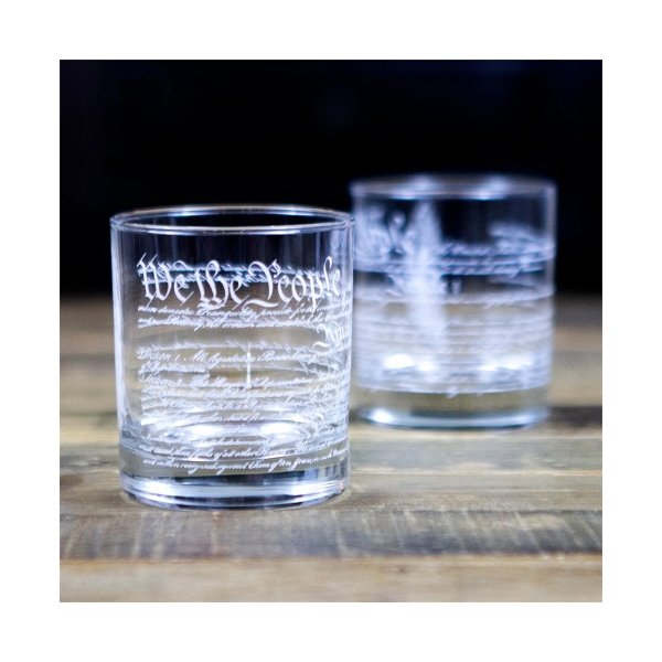 Whiskey glass with the preamble to the U.S. Constitution etched in side.