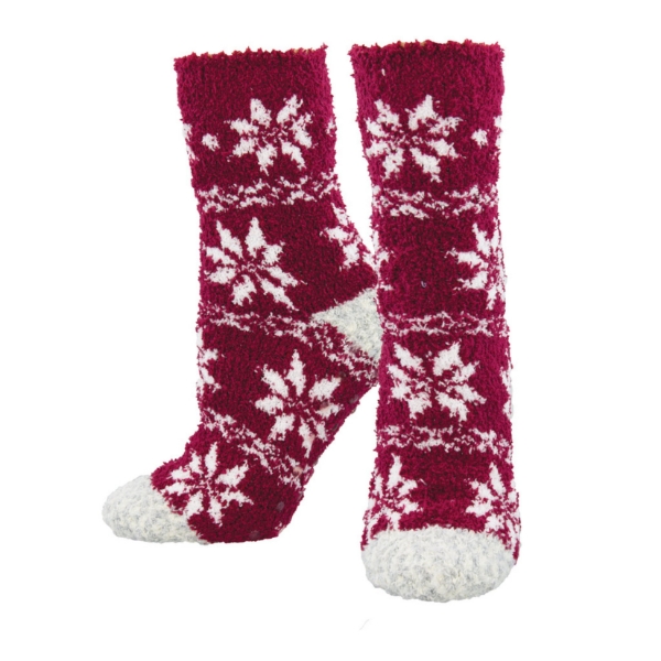 Fuzzy red socks with pattern of large white snowflakes.